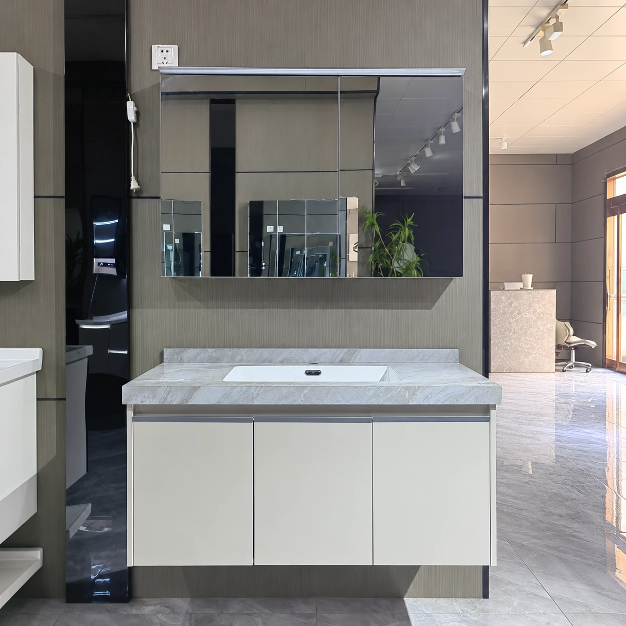 Mueble de baño multiespacio en tono claro con encimera texturizada - Zona de lavabo del baño