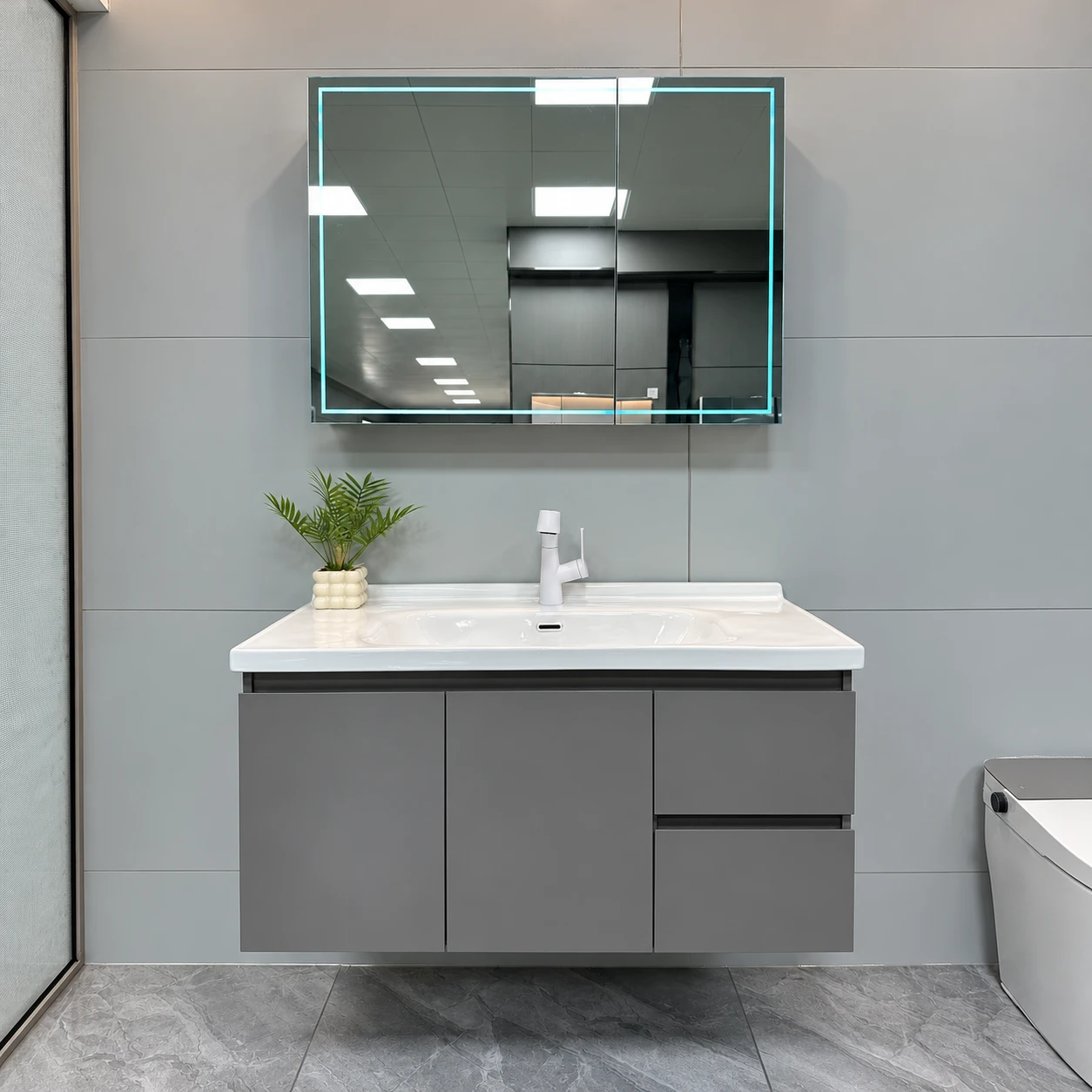 Dark gray bathroom vanity with illuminated mirror cabinet - Bathroom Vanity Area